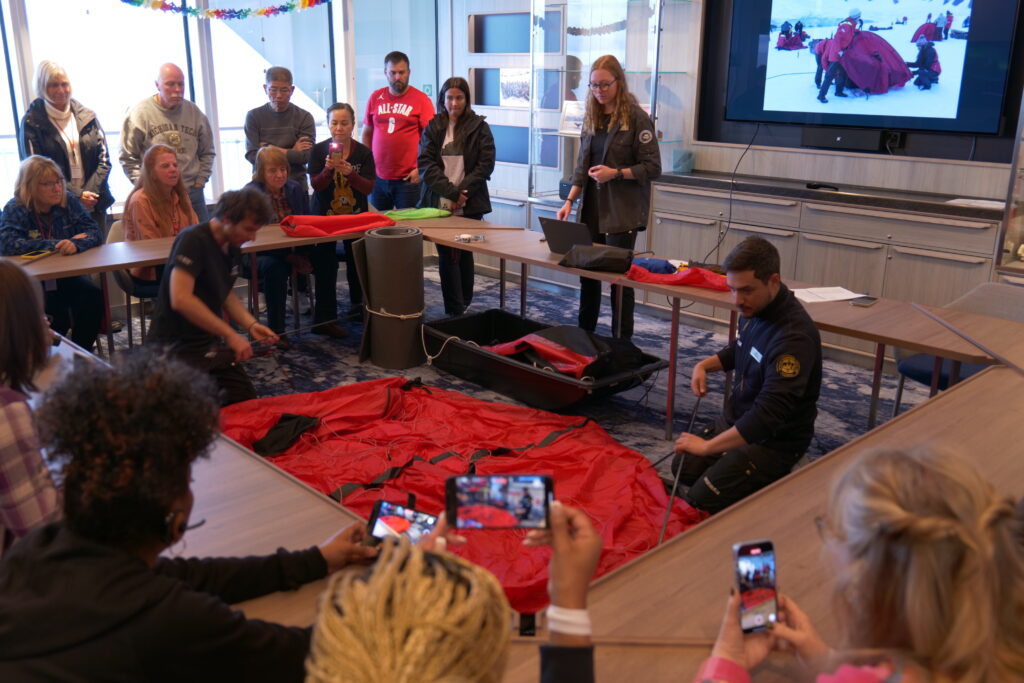 Practice camp: Setting up tents in the ship's boardroom ahead of a night on Antarctica. Photo / Thomas Bywater 