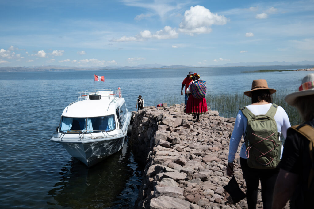 Carrying bags to a water taxi on Lake Titicaca, Peru. Photo / Thomas Bywater